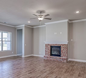 Living Room Brick Fireplace Ceiling Fan Wood Floors