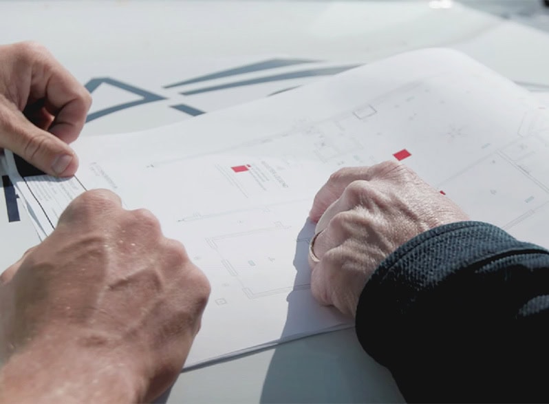 Reviewing House Blueprint On Construction Site