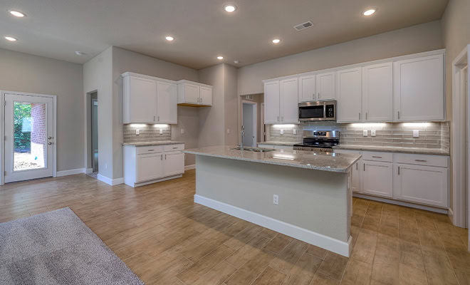 Open Kitchen White Cabinets Light Wood Flooring