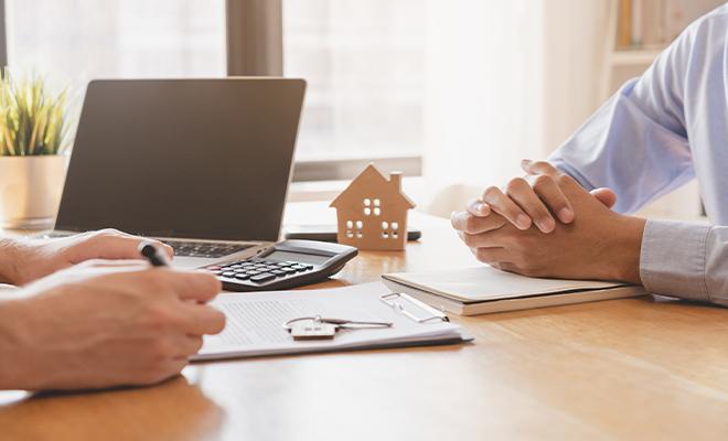 Real Estate Agent Showing Home To Buyers