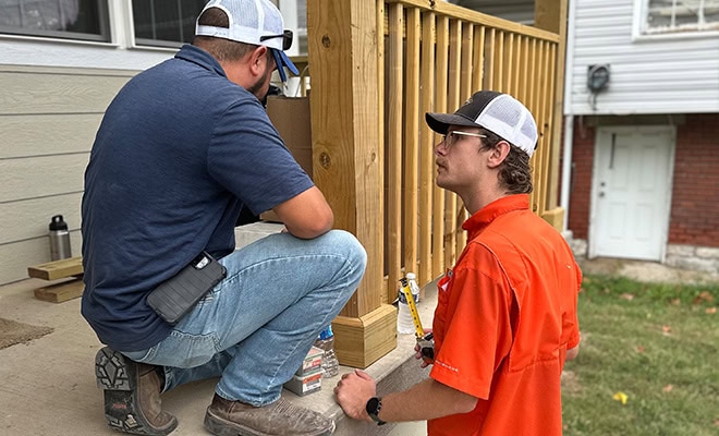 Construction Workers On Home Porch
