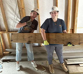 Team Working On House Floor Framing