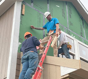 Volunteer Smiling Framing House