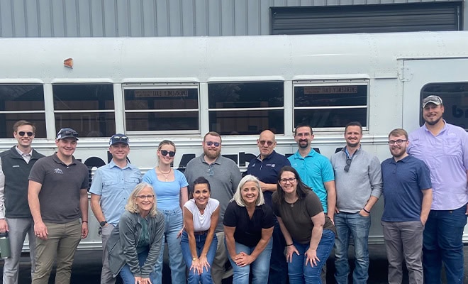 Volunteer Group Photo In Front Of Bus